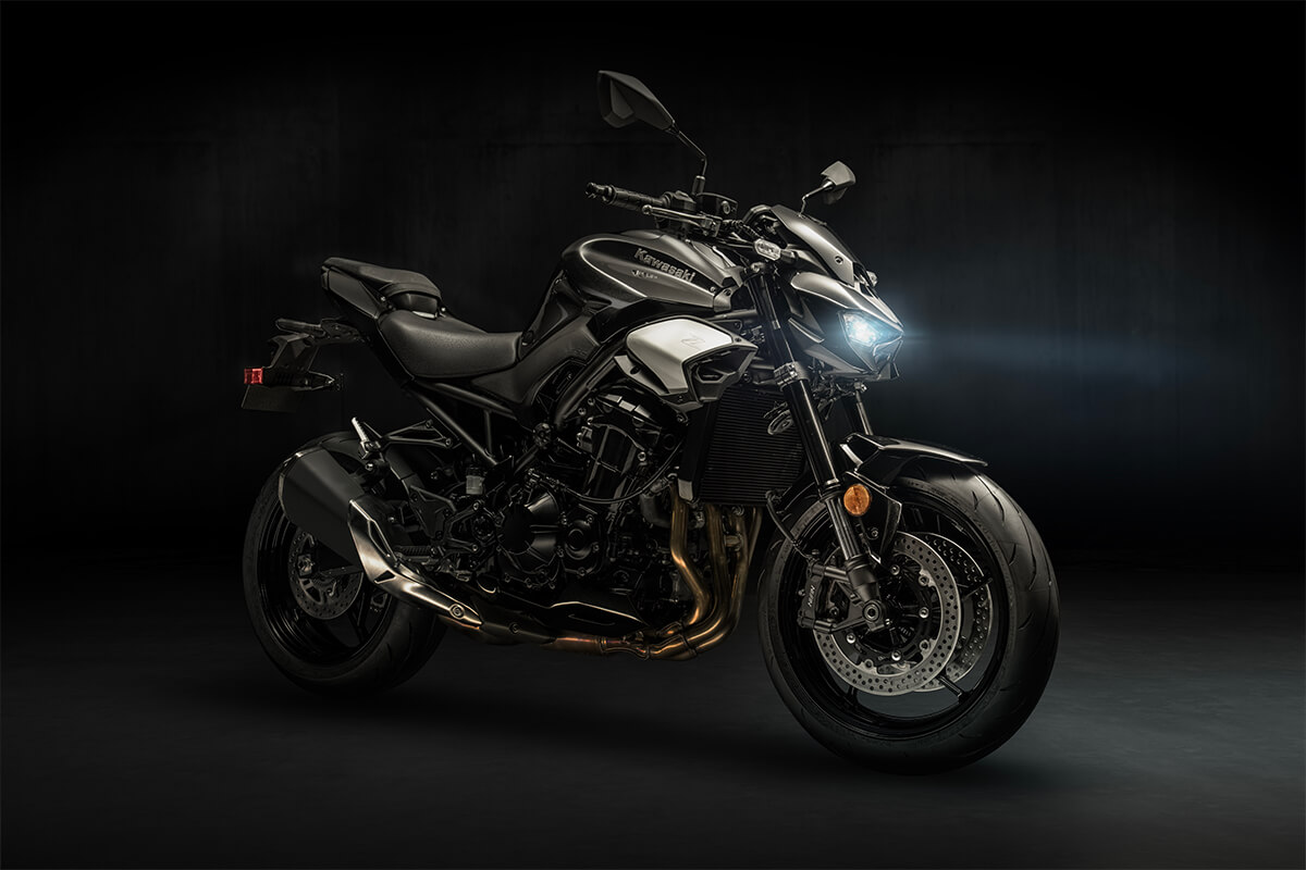 Profile angle of a motorcycle staged in a dark studio.