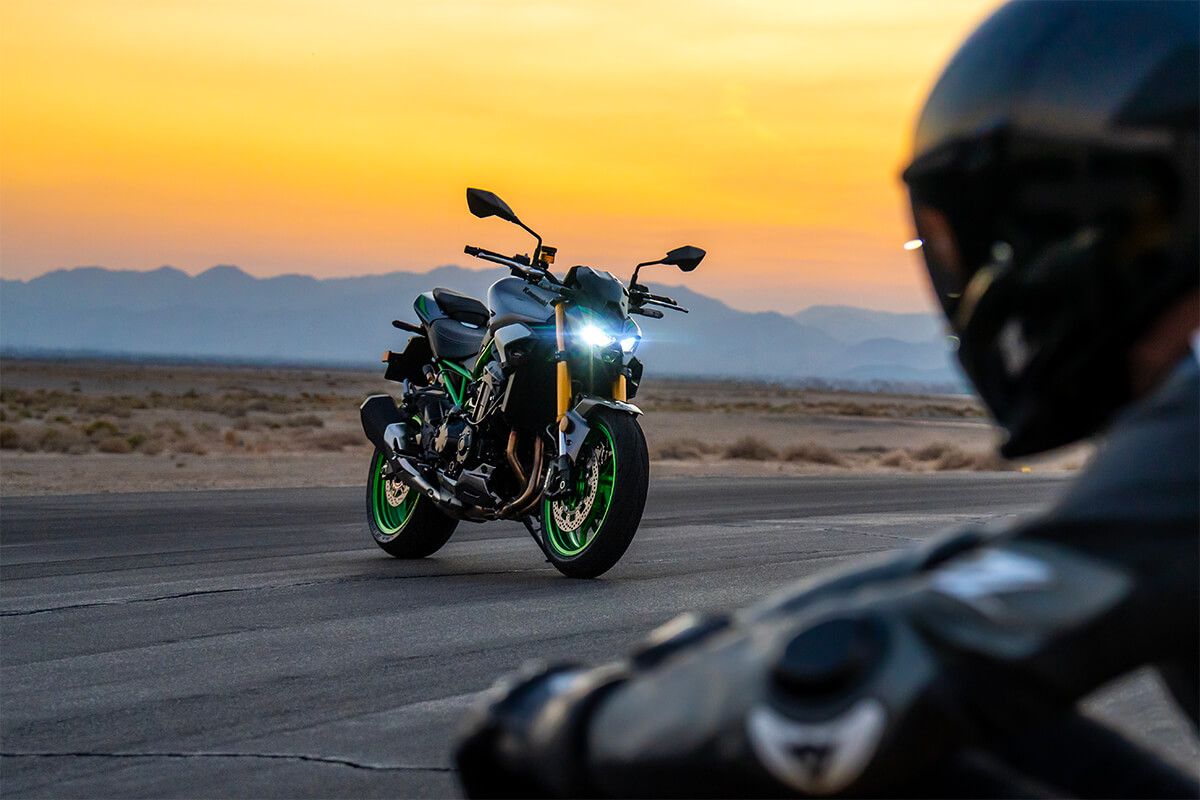 Three-quarter front angle of a motorcycle staged on a track during golden hour.