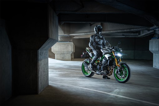 Profile angle of a rider on a motorcycle in a parking garage. opens in a new window