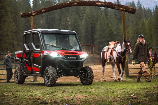 Front three-quarter angle of a side x side on a ranch next to a horse. opens in a new window