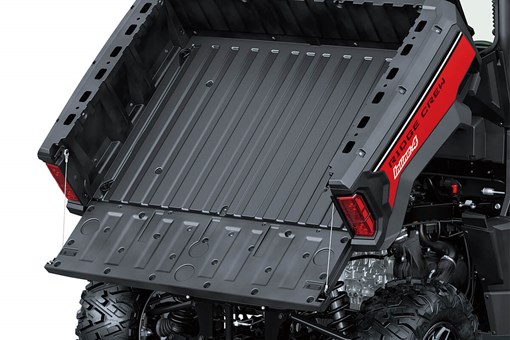 View of a cargo bed of a side x side in raised position with the tailgate down. opens in a new window