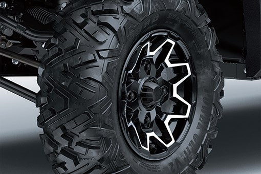 Detail view of the front right wheel and tire of a side x side. opens in a new window