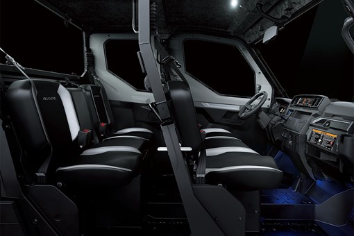 Profile view of interior of a side x side showing passenger seating in dark studio background. opens in a new window