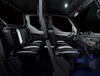 Profile view of interior of a side x side showing passenger seating in dark studio background.