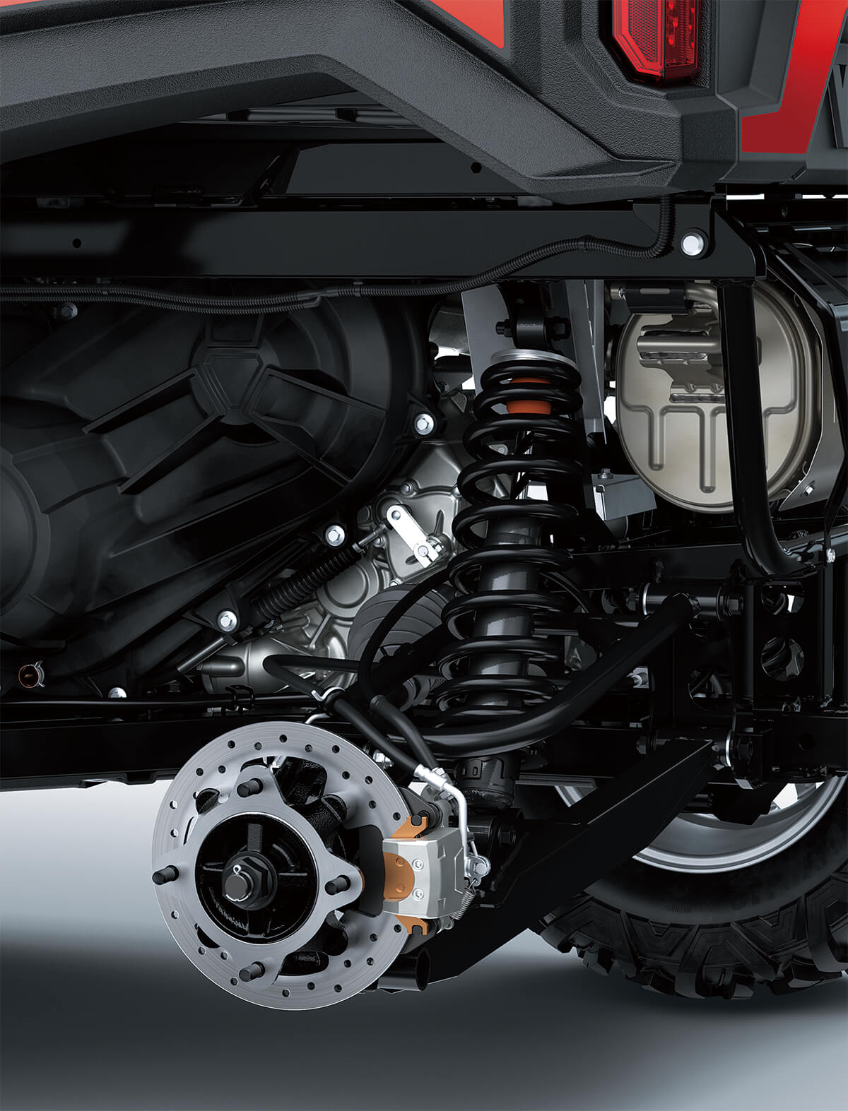 Detail view of rear right suspension system and brake rotor of a side x side.