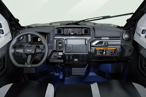 Interior cabin view of the front dash and controls of a side x side with floor accent lighting. opens in a new window