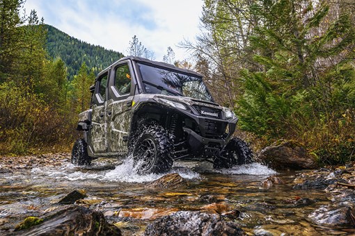 Front three-quarter action photo of a side x side traversing a river. opens in a new window
