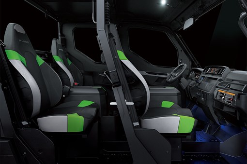 Profile view of interior of a side x side showing passenger seating in dark studio background. opens in a new window