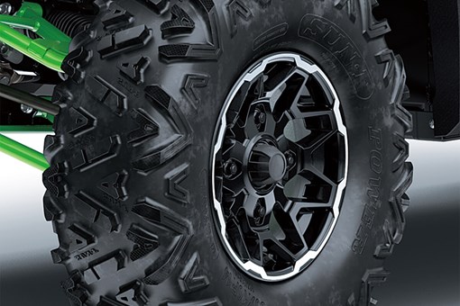 Detail view of the front right wheel and tire of a side x side. opens in a new window