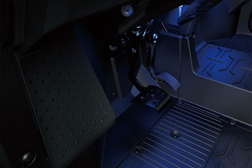 Interior view of foot controls of a side x side with lower accent lighting. opens in a new window