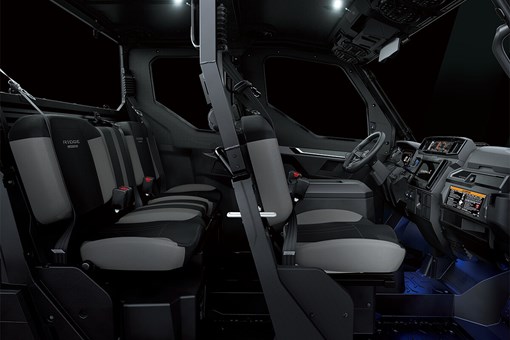Profile view of interior of a side x side showing passenger seating in dark studio background. opens in a new window