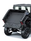 View of a cargo bed of a side x side in raised position with the tailgate down.