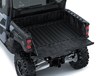 Top-down view of cargo bed of a side x side with the tailgate down.