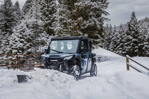 Front three-quarter angle of a side x side plowing snow. opens in a new window