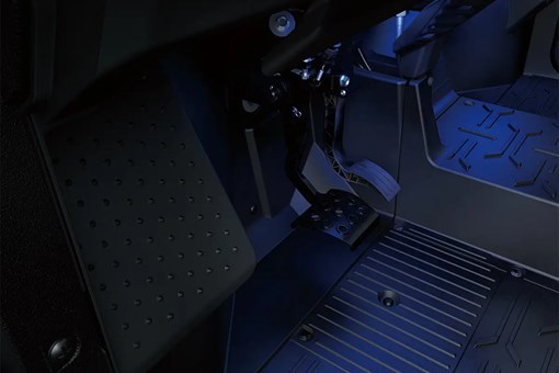 Interior view of foot controls of a side x side with lower accent lighting. opens in a new window