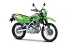 Right three-quarter view of a green dual-sport motorcycle staged in a white studio background.