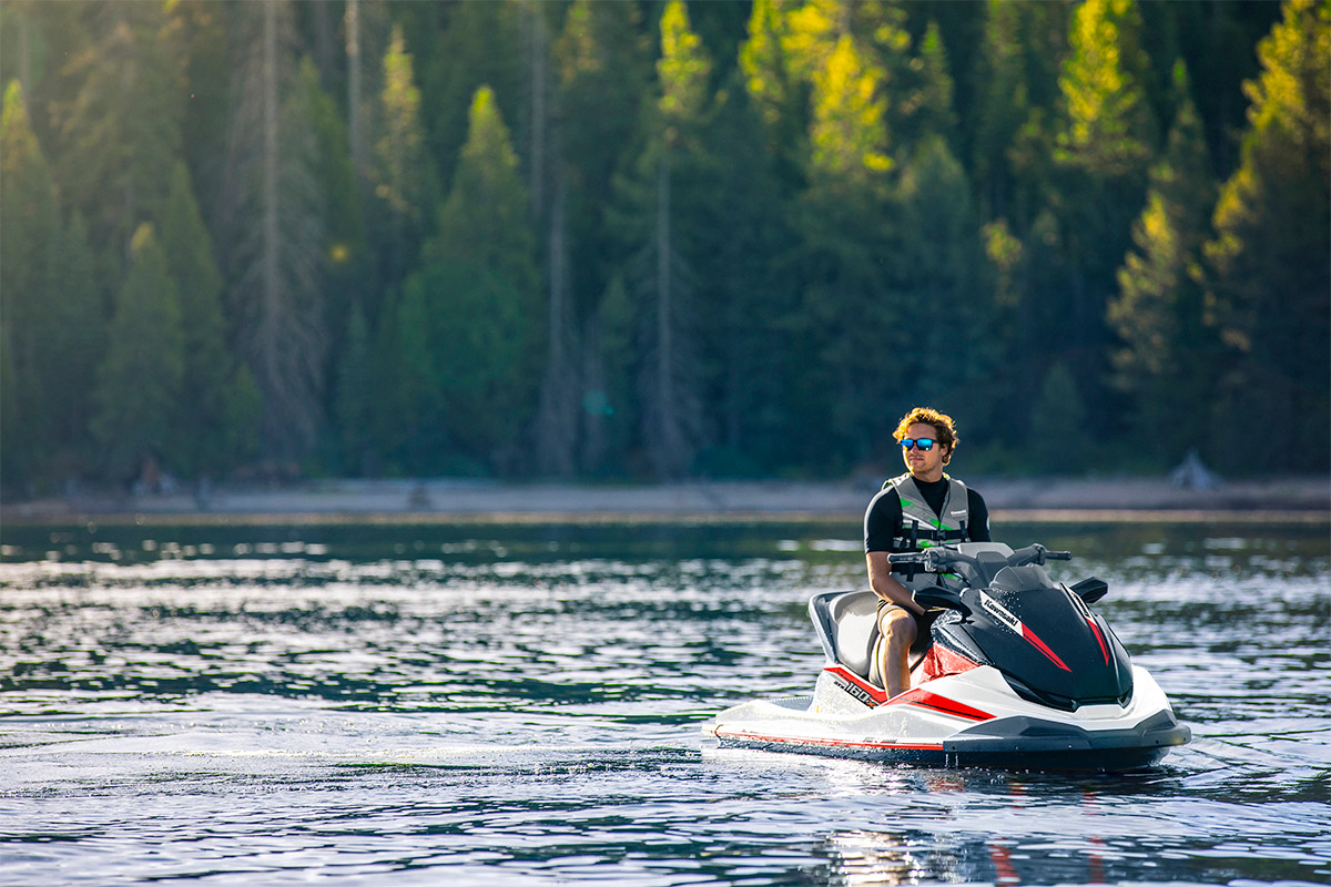 Front view of a person sitting on a personal watercraft in calm water.