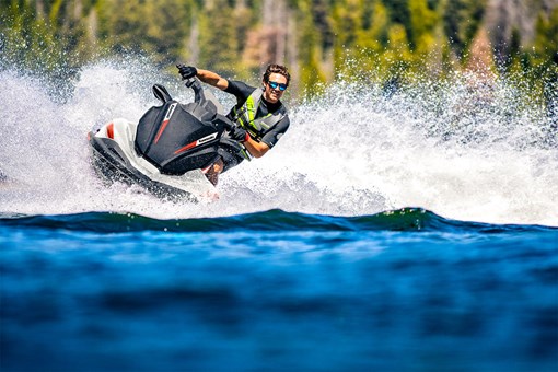 Front view of a person in action on a personal watercraft on the water. opens in a new window