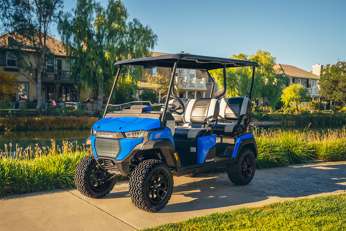 Three-quarter front angle of Neighborhood Activity Vehicle staged on a driveable sidewalk.