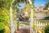 Profile view of a family riding in a Neighborhood Activity Vehicle on a community roadway.