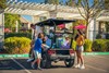 Rear angle of a family exiting a parked Neighborhood Activity Vehicle.