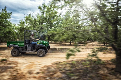 Side angle of a person driving a side x side on a ranch. opens in a new window