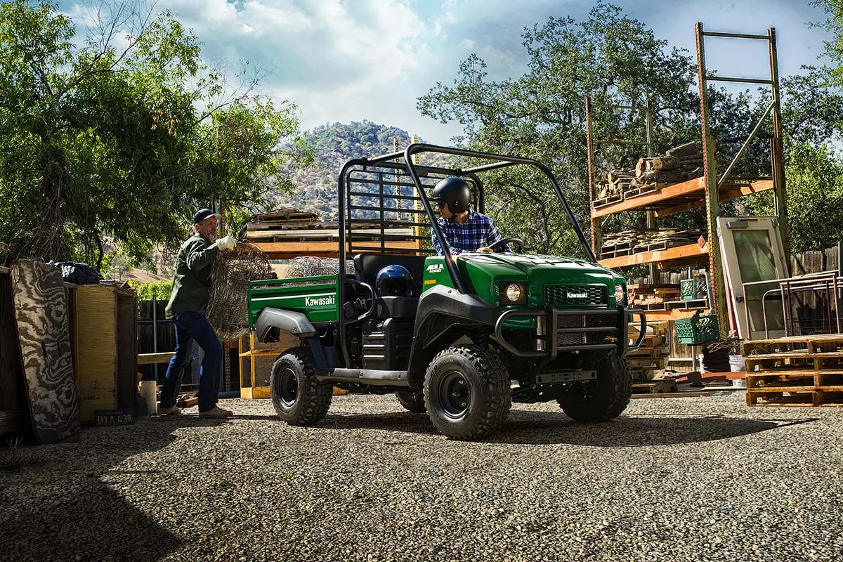Three-quarter front angle of a green side x side parked on a jobsite.