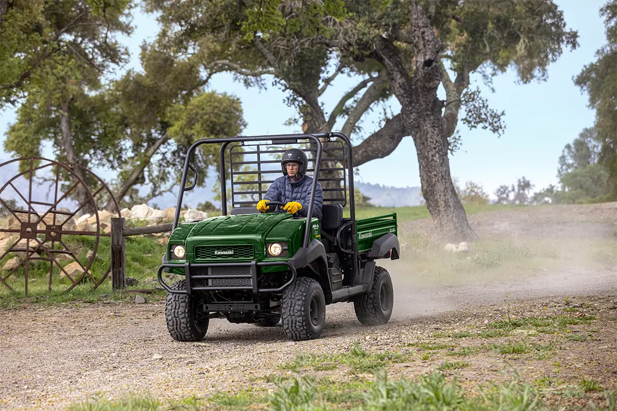 Front angle of a person driving a side x side at a ranch.