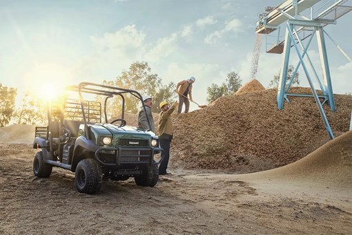 Three-quarter front angle of a green side x side parked off-road. opens in a new window
