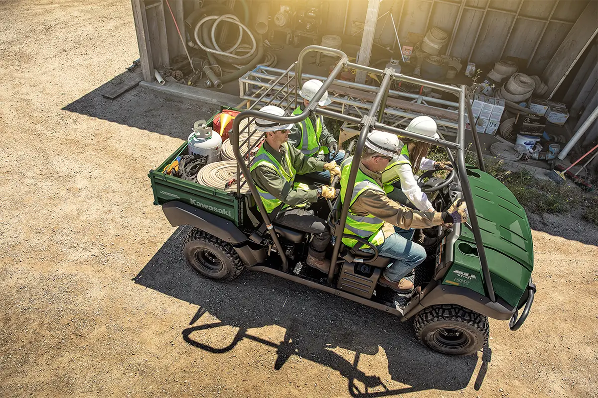 Aerial view of four people driving a side x side off-road.