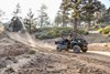 Side angle of a person driving a side x side off-road.
