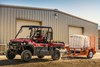 Side angle of a person driving a side x side on a jobsite.