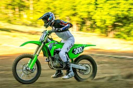 Side angle of a person riding a motorcycle on a dirt track. opens in a new window