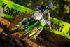 Front angle of a person riding a motorcycle on a dirt track.
