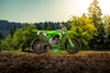 Side angle of a motorcycle staged on a dirt track.