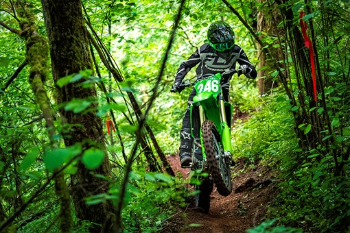 Front angle of a person riding a motorcycle on an off-road course. opens in a new window