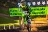 Front angle of a person riding a motorcycle on a dirt track.