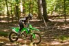 Side angle of a person riding a motorcycle on an off-road course.