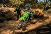 Front angle of a person riding a motorcycle off-road under adult supervision.