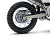 Close-up view of the rear tire of a motorcycle staged in a white studio background.