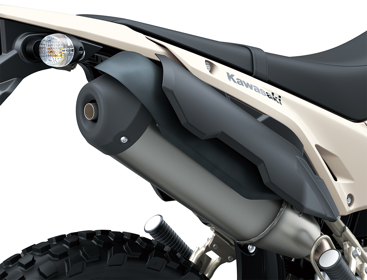 Close-up view of the exhaust of a motorcycle staged in a white studio background.