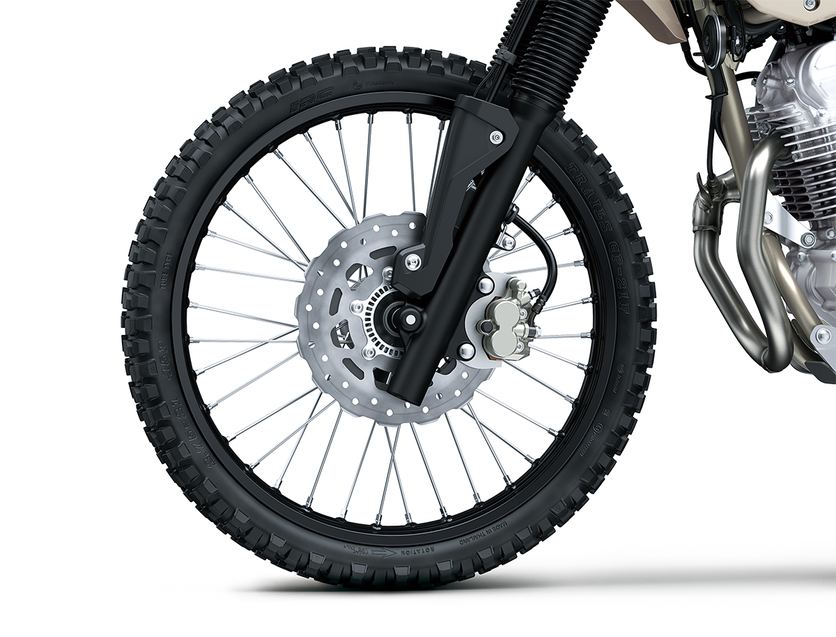 Close-up view of the front tire of a motorcycle staged in a white studio background.