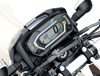 Close-up view of the LCD dash meter of a motorcycle staged in a white studio background.