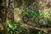 Side angle of a person riding a motorcycle off-road.