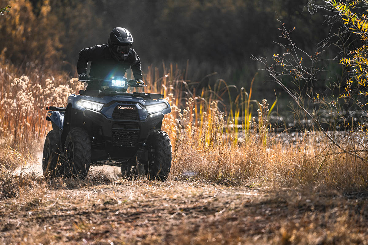 Front angle of a person riding an ATV off-road.