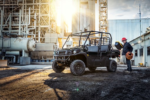 Three-quarter front angle of a person loading the bed of a parked side x side at a jobsite. opens in a new window