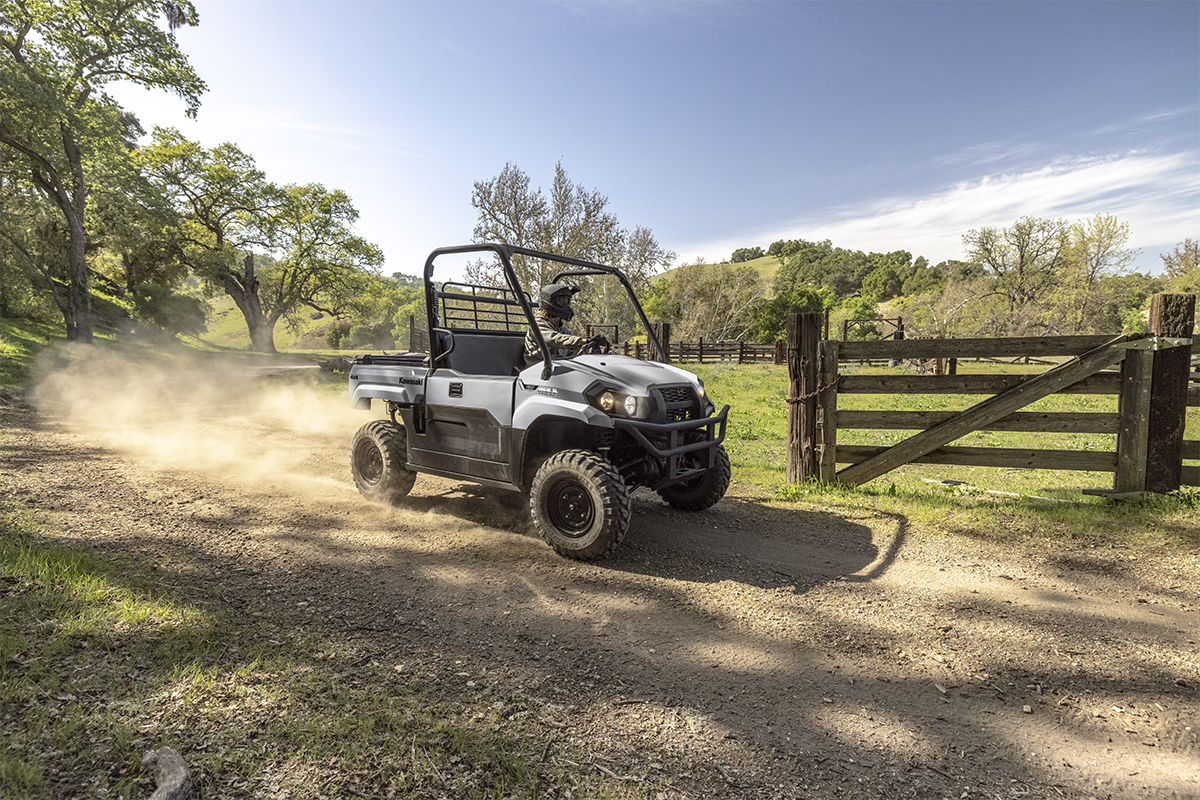 Three-quarter front angle of a person driving a side x side on a ranch.