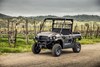 Three-quarter front angle of a side x side parked off-road.