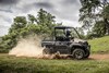 Side angle of a person driving a side x side off-road.