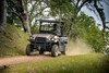 Three-quarter front angle of a person driving a side x side off-road.